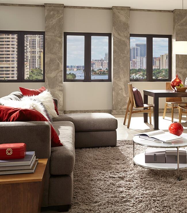 Living room view through secure dark-frame Hurricane Windows in Pinellas County, FL.