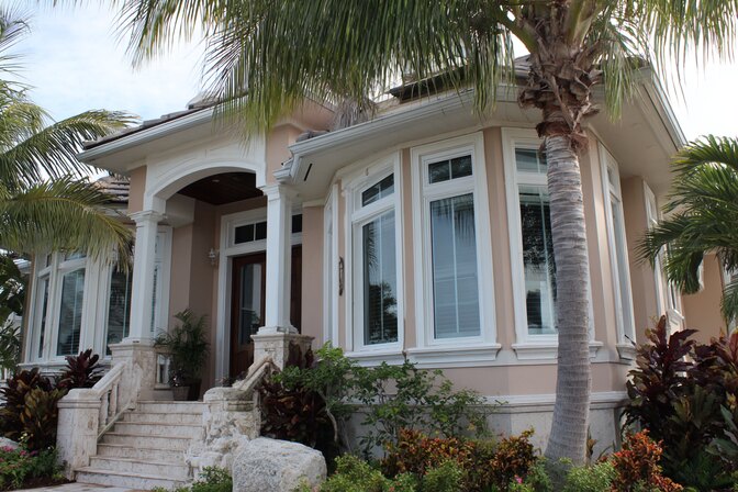 Luxury home exterior with palm trees and custom Irvine, CA Windows enhancing architectural elegance and curb appeal