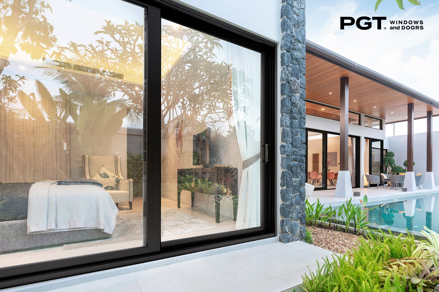 PGT WinGuard Vinyl sliding glass patio door with a black frame and two-panel configuration.
